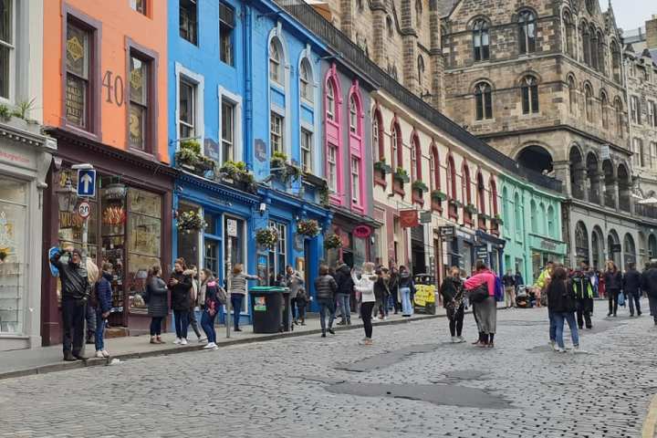 a group of people walking in front of a building
