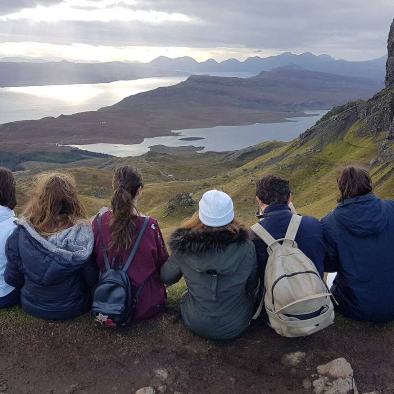 a group of people sitting on top of a mountain